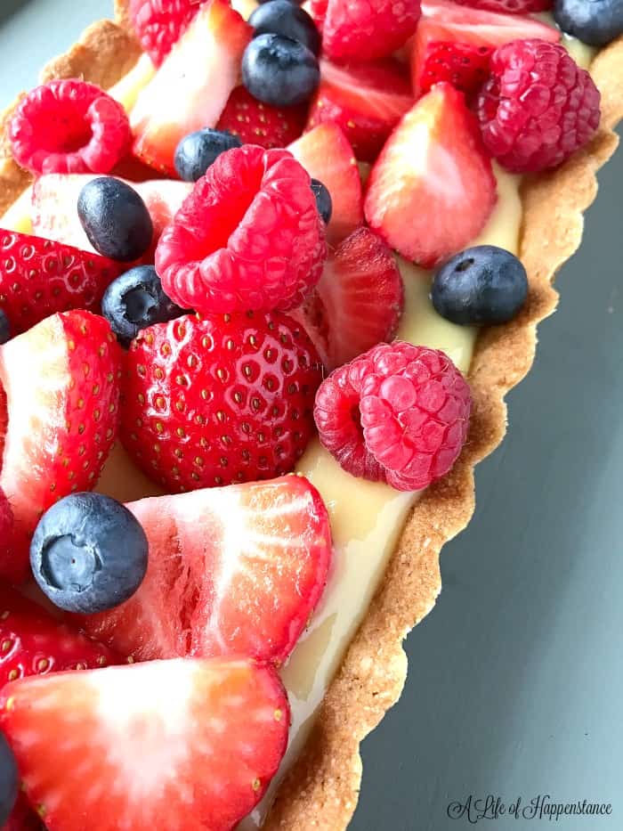 Close up of the Paleo Lemon Tart topped with fresh berries. 