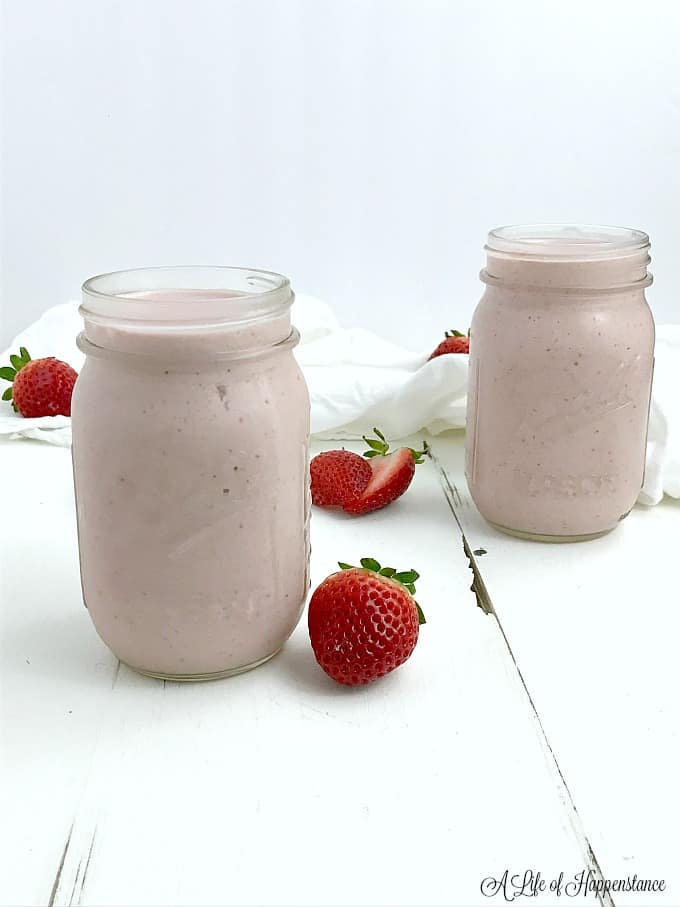 Two mason jars filled with smoothie. 
