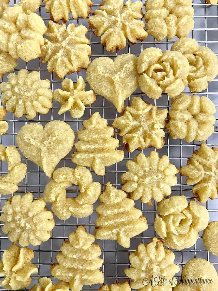 almond flour spritz cookies on a metal cooling rack.