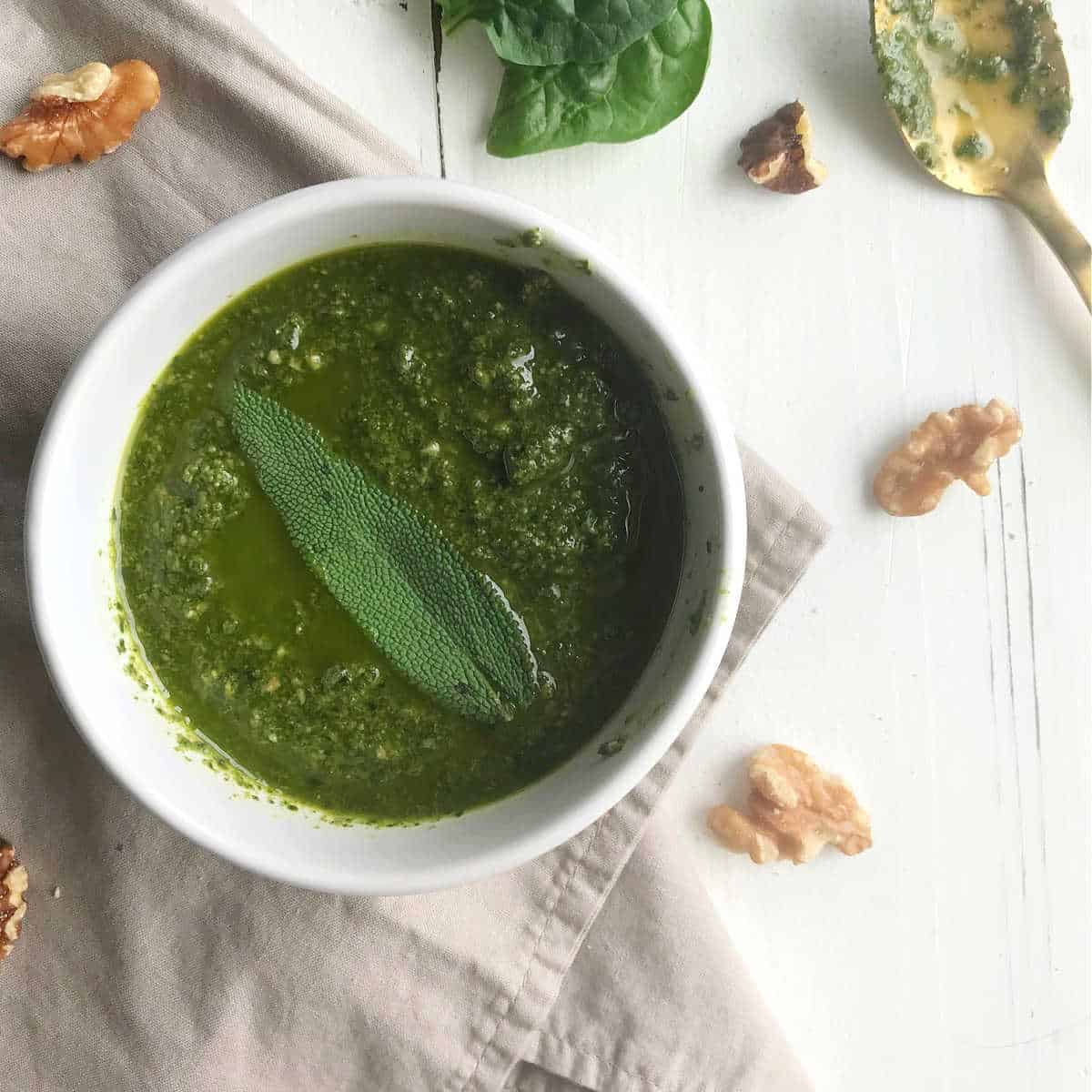 A white bowl filled with pesto.