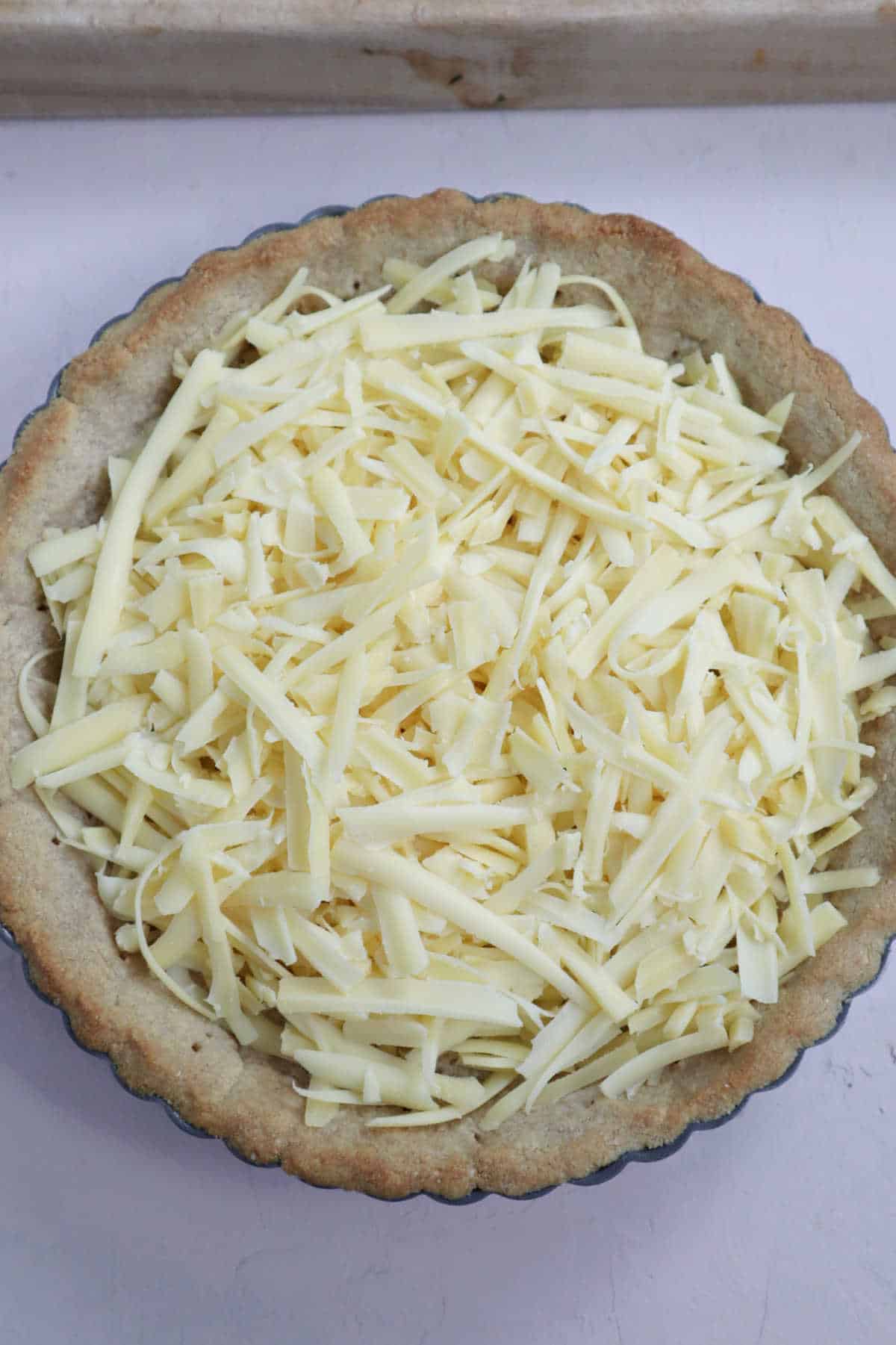 Shredded cheese in a baked crust.