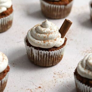 A cupcake sprinkled with ground cinnamon on a table.